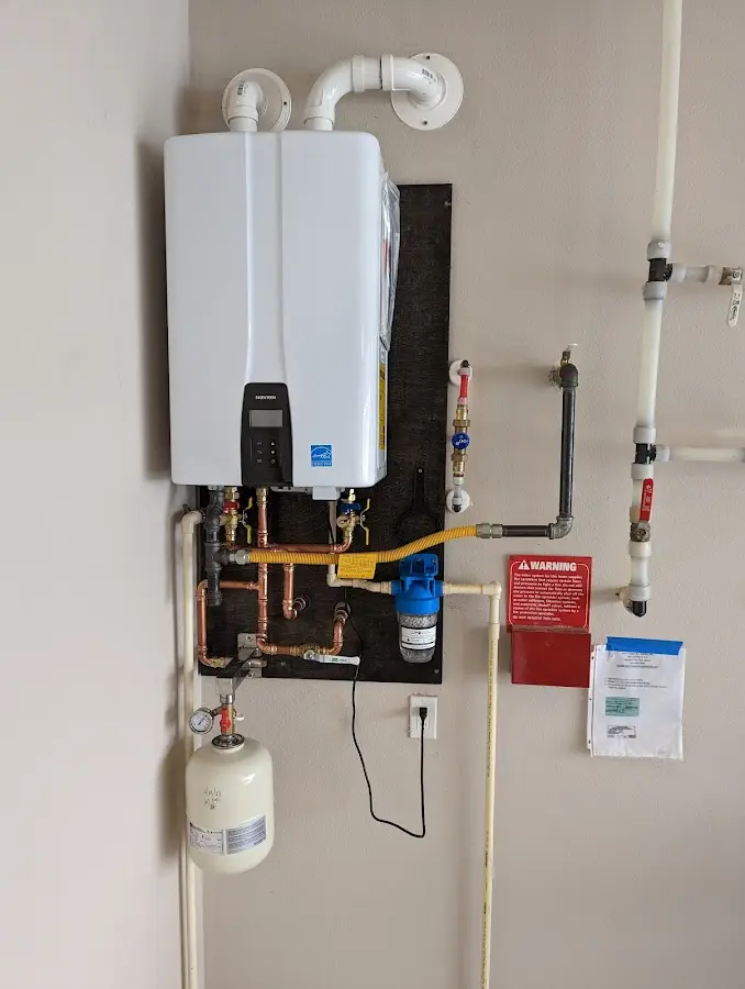 Professional plumber installing copper piping in a Henrietta home