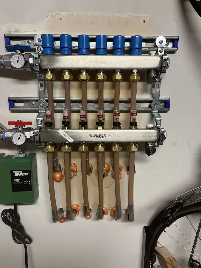 Plumber performing Water Heater Repair at a residential property in Henrietta